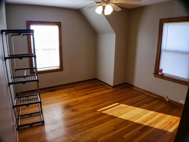 a view of a room with wooden floor and stairs