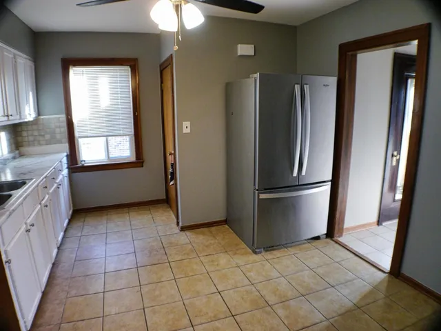 a kitchen with a refrigerator a sink and cabinets
