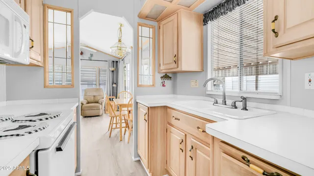 a kitchen with a sink stove and cabinets