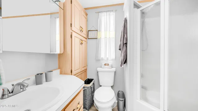a white toilet sitting next to a bathroom sink