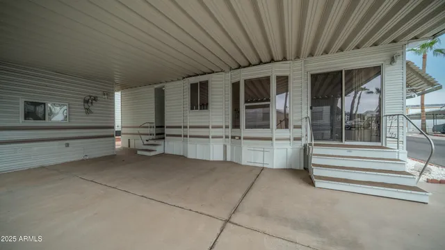 a view of a house with a barbeque grill and couches