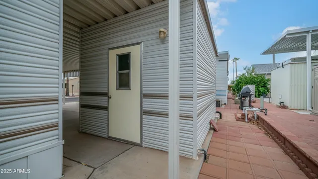 a view of a house with backyard and sitting area