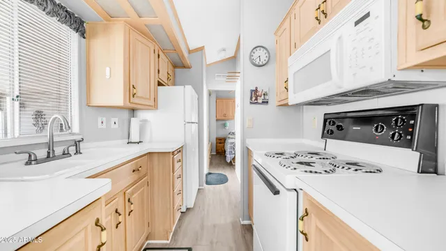 a kitchen with stainless steel appliances kitchen island granite countertop a sink stove and refrigerator