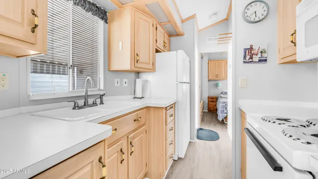 a kitchen with a sink a stove and a refrigerator