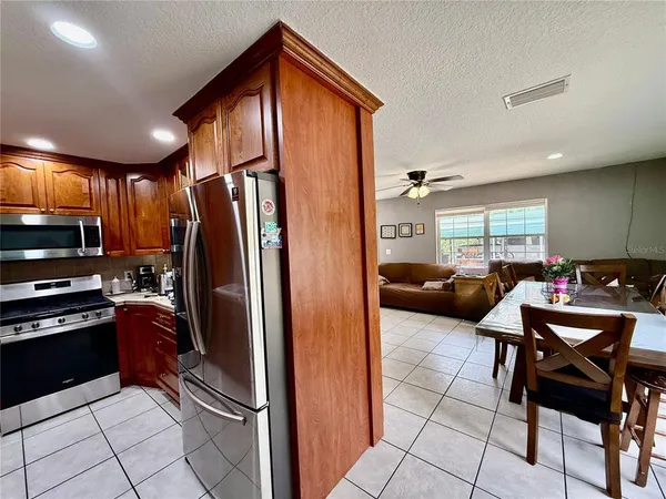 a kitchen with stainless steel appliances a refrigerator and a stove top oven