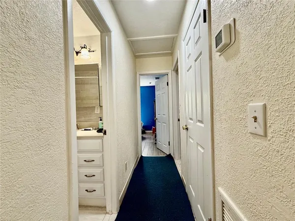 a view of a hallway with a wooden door