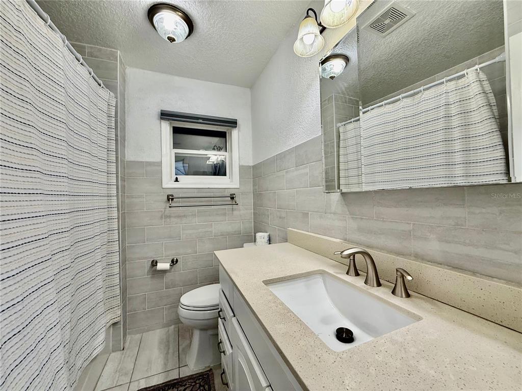 1363 Emporia Road Pierson, FL 32180 - Photo 14 of 27 a bathroom with a sink a toilet and mirror