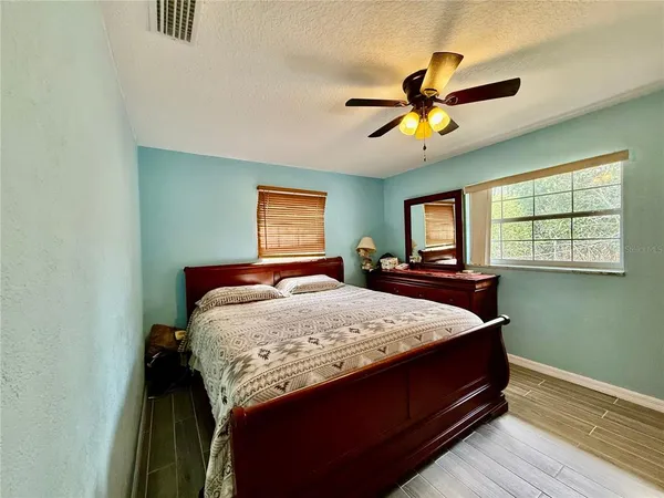 a bed sitting in a bedroom next to a window