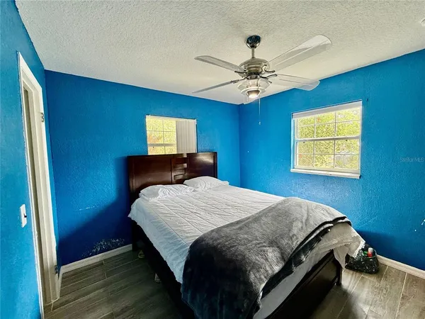 a bedroom with a bed and a window