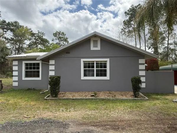 a house that has a tree in front of it