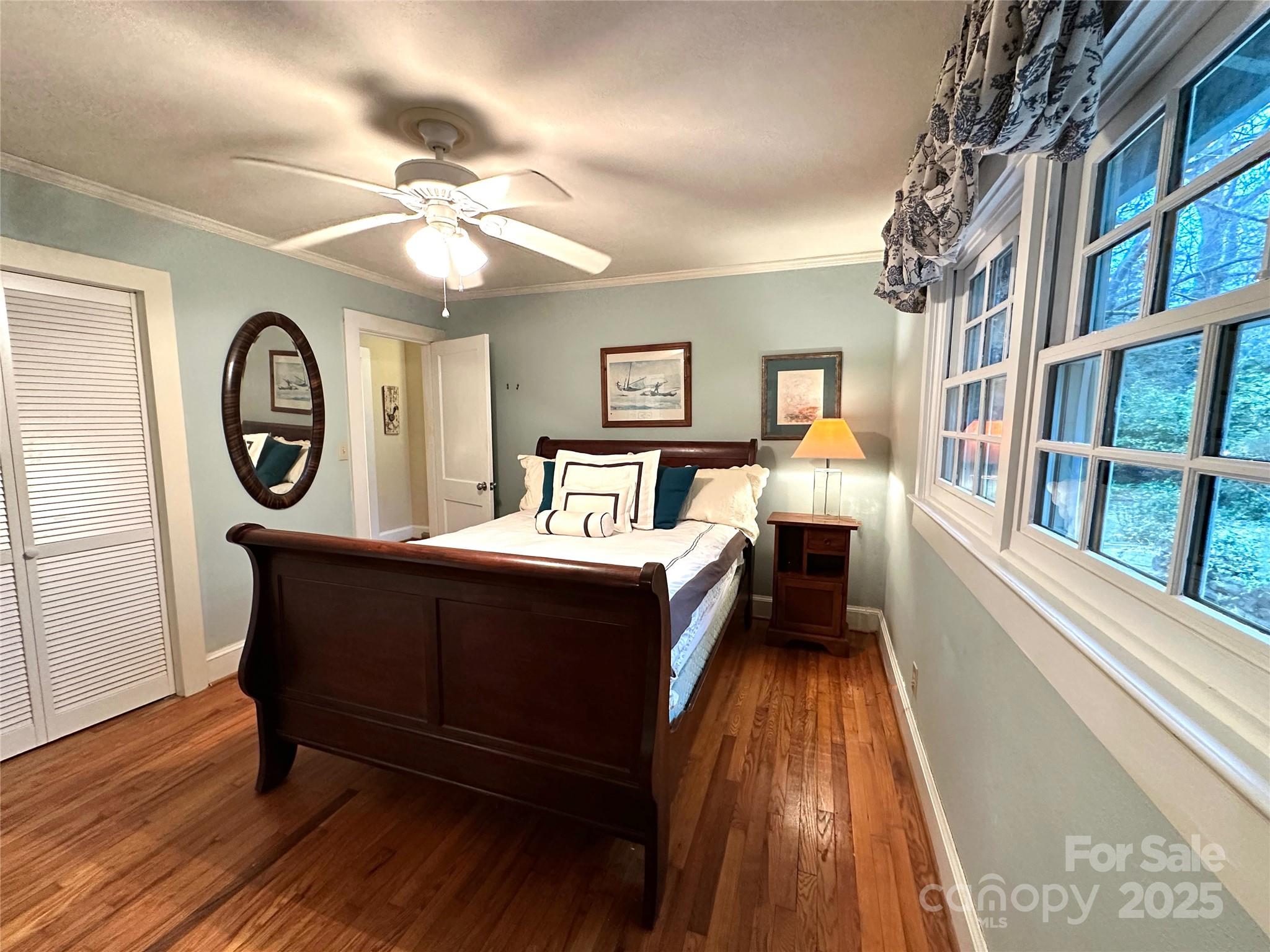 105 Melrose Lane Tryon, NC 28782 - Photo 11 of 35 a bedroom with a bed and a chandelier