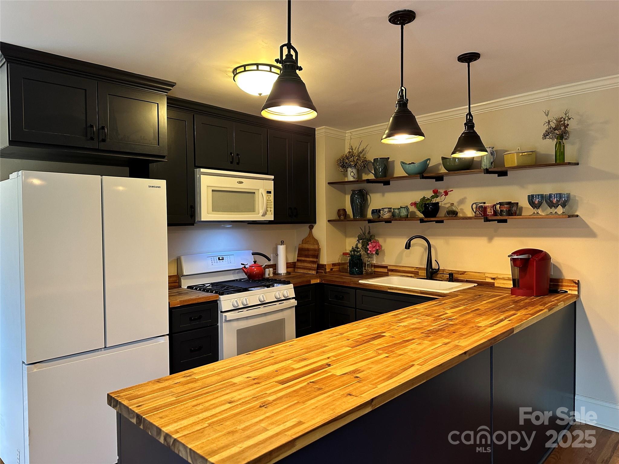 105 Melrose Lane Tryon, NC 28782 - Photo 20 of 35 a kitchen with stainless steel appliances granite countertop a sink a stove and refrigerator