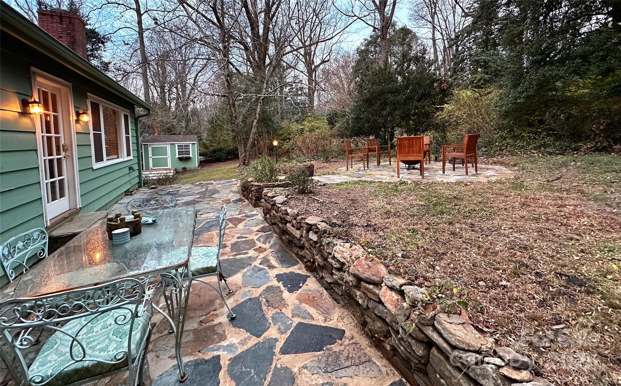 105 Melrose Lane Tryon, NC 28782 - Photo 2 of 35 a backyard of a house with outdoor seating