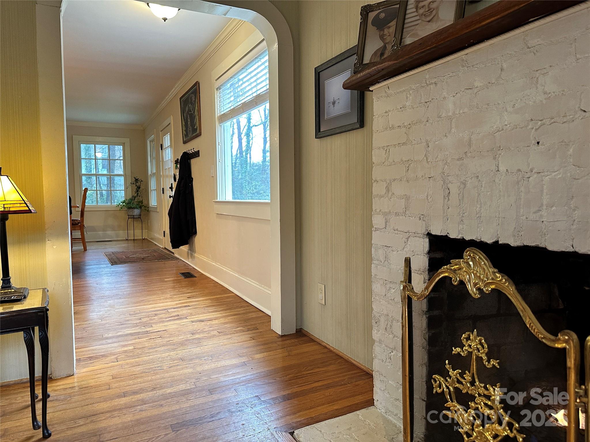 105 Melrose Lane Tryon, NC 28782 - Photo 22 of 35 a view of a hallway with wooden floor and a living room