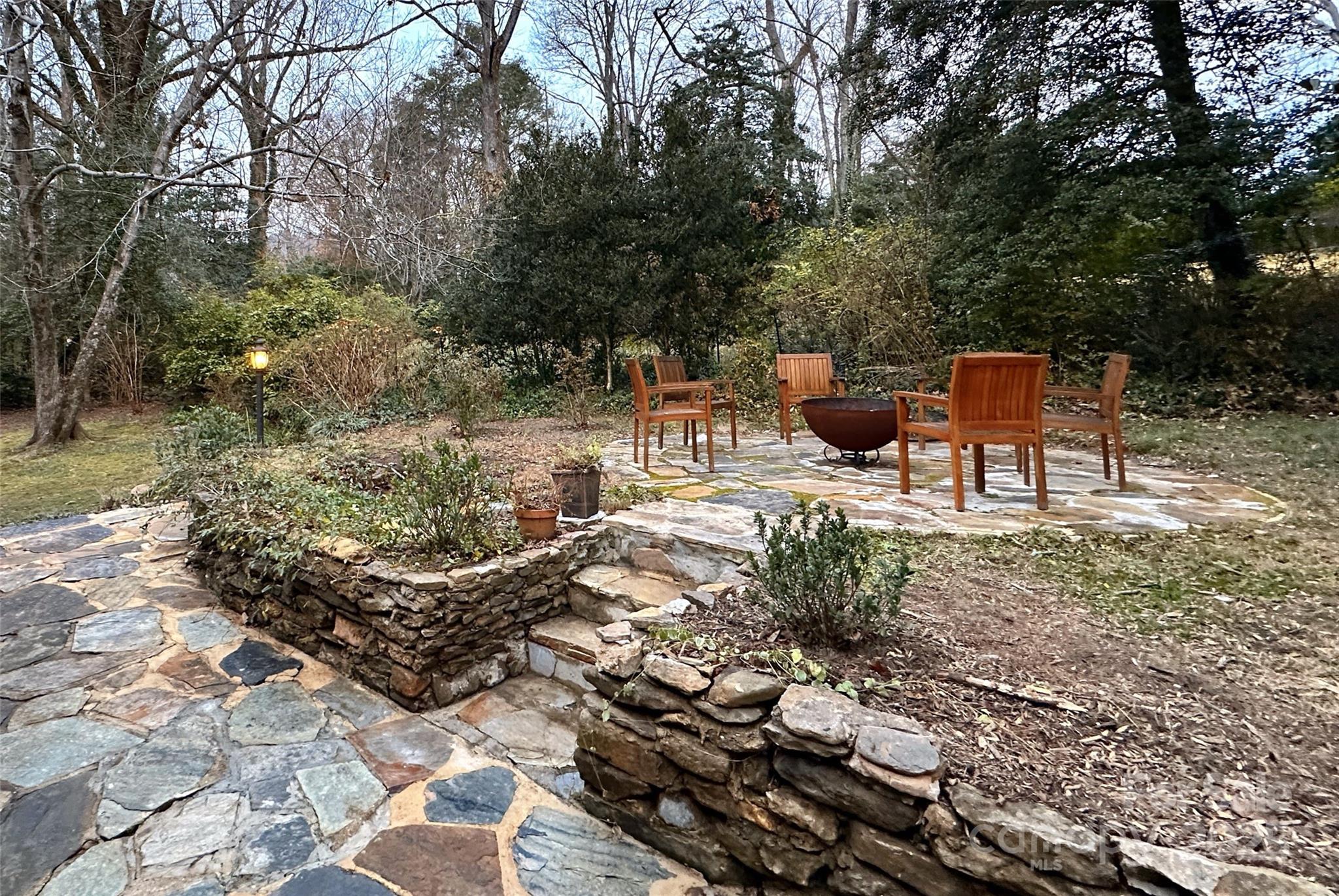 105 Melrose Lane Tryon, NC 28782 - Photo 25 of 35 a view of a chairs and fire pit in the backyard