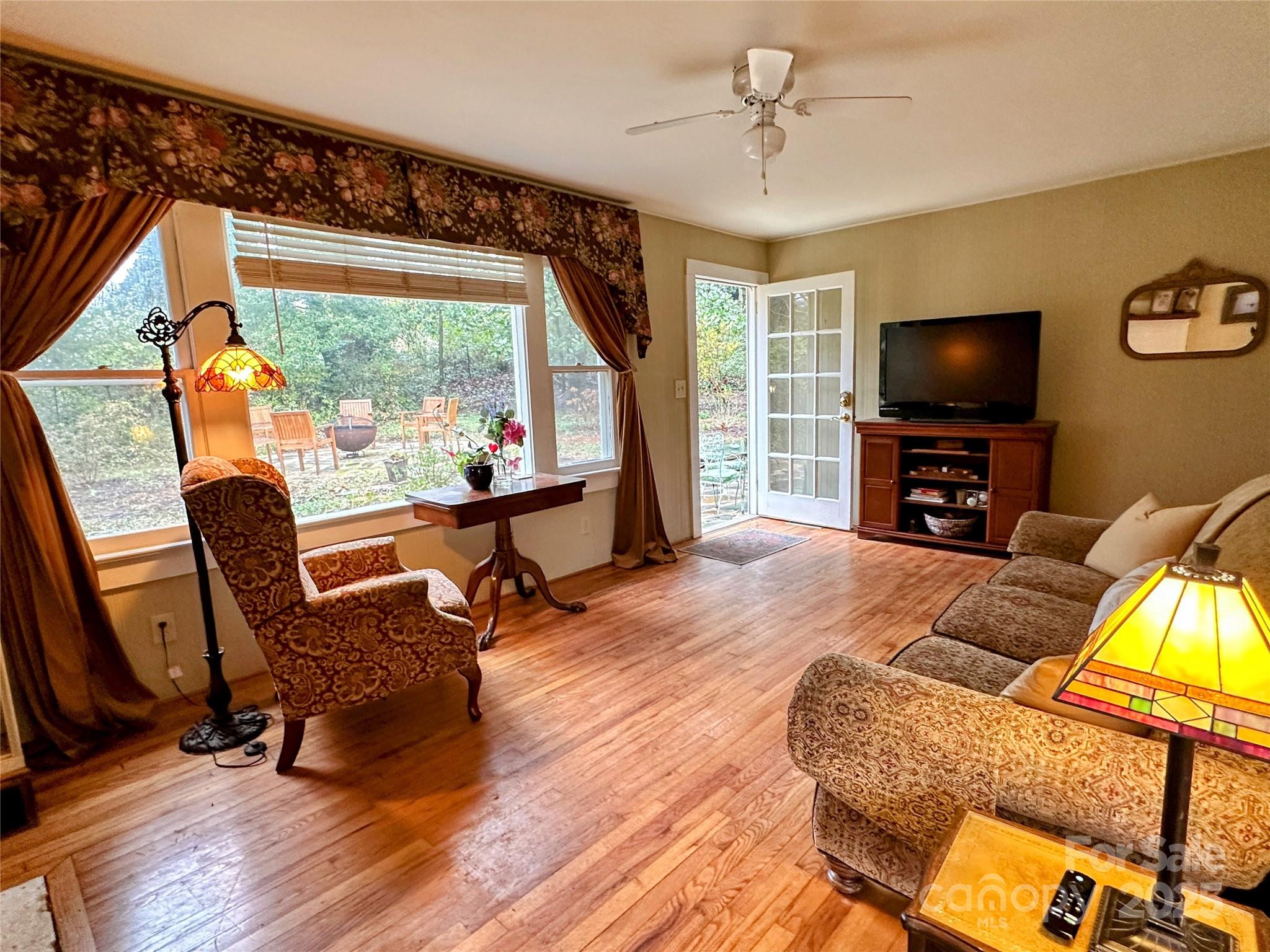 105 Melrose Lane Tryon, NC 28782 - Photo 9 of 35 a living room with furniture and a flat screen tv with wooden floor