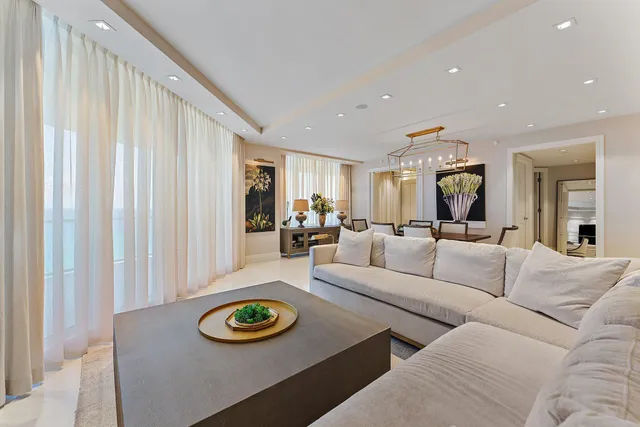 a living room with furniture a flat screen tv and a window