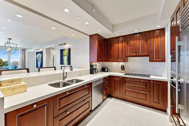 a kitchen with a sink appliances and cabinets