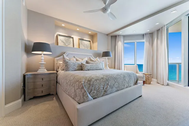 a spacious bedroom with a bed and a flat screen tv