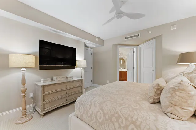 a bedroom with a bed and large window