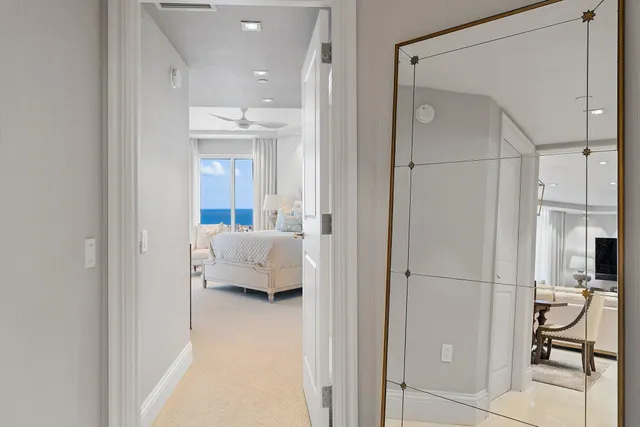 a bathroom with a toilet a sink and a large mirror