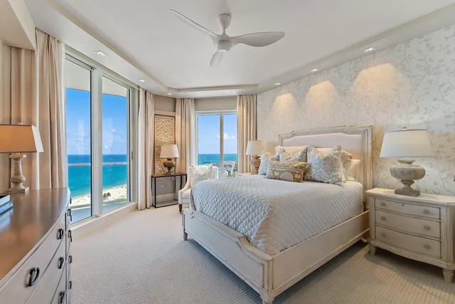 a living room with furniture a rug and a large window