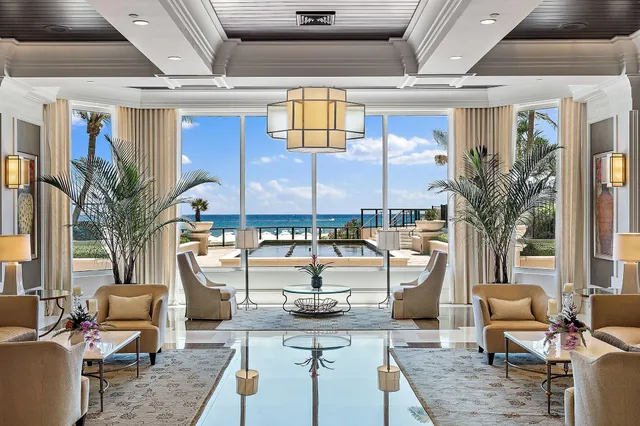 a front view of multiple houses with yard and green space