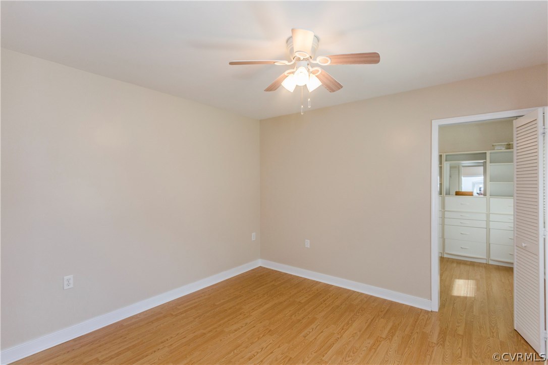 3843 Treely Road Chester, VA 23831 - Photo 15 of 50 an empty room with wooden floor and chandelier fan