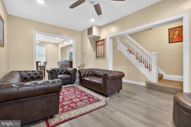 a living room with furniture and a wooden floor