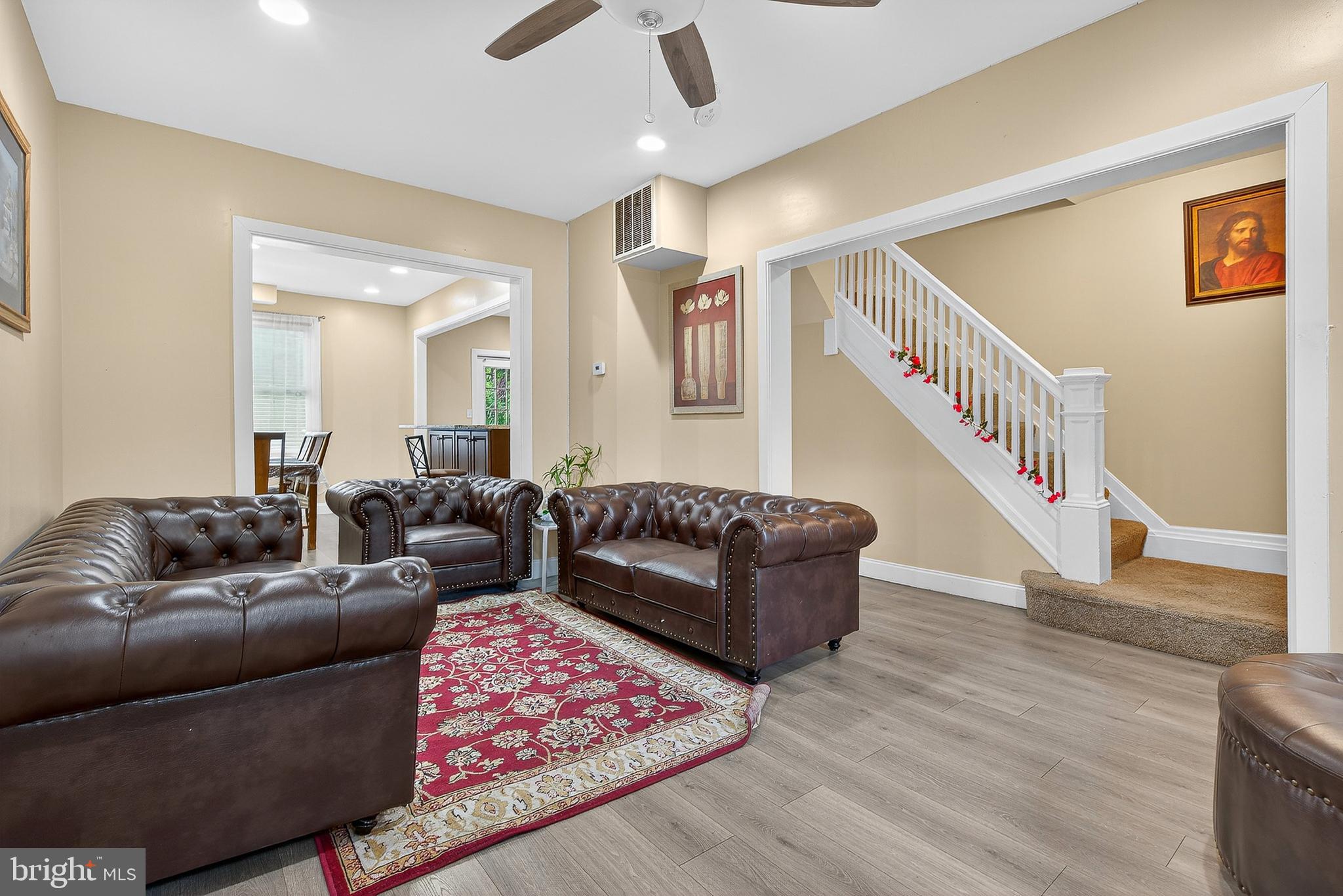 a living room with furniture and a wooden floor