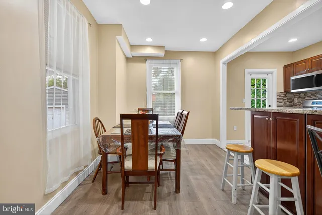 a dining room with furniture and wooden floor