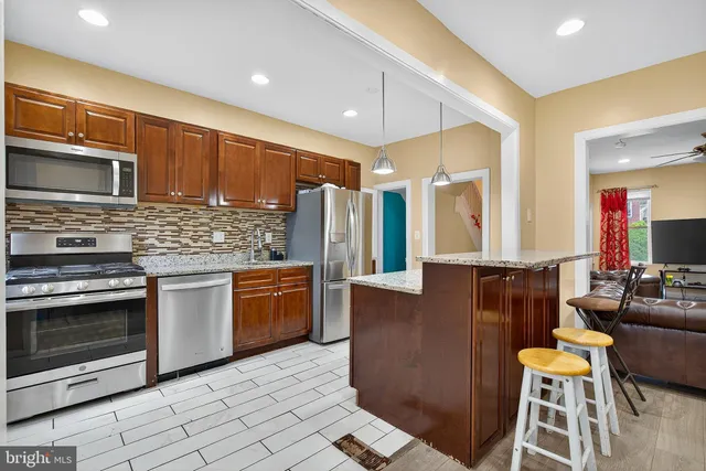 a kitchen with sink cabinets and wooden floor