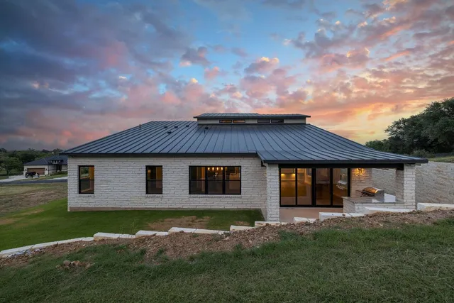 a front view of house with yard and green space