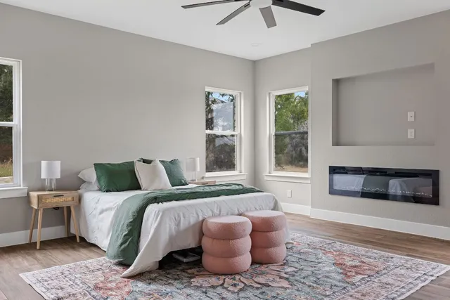 a bedroom with a bed and a large window