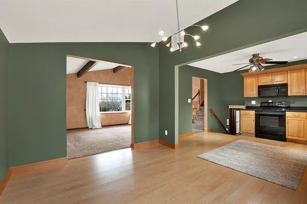 a view of a kitchen with a sink and a large window