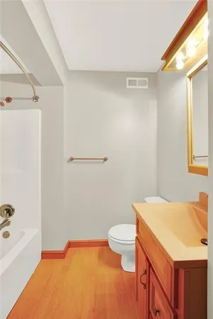a bathroom with a sink a toilet and bathtub