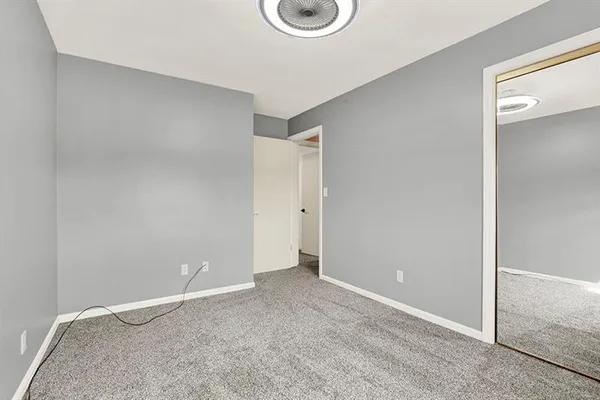 a room with a window and ceiling fan