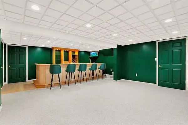 a view of a house with a big yard and potted plants