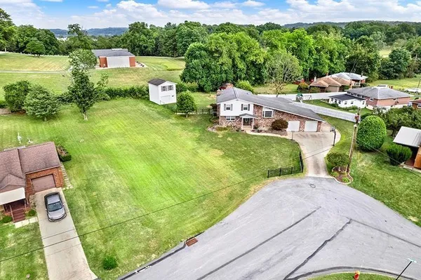 a aerial view of a house with garden space and street view