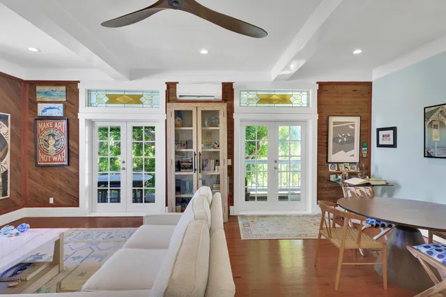 a living room with furniture and large windows