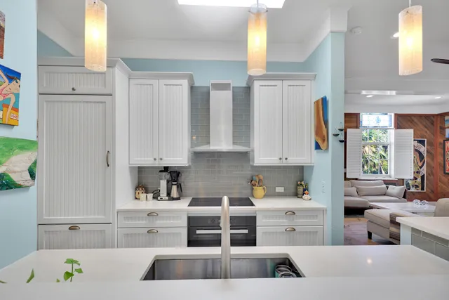 a kitchen with white cabinets and white appliances