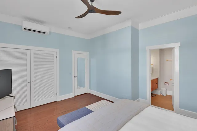 a bedroom with a bed and a hallway