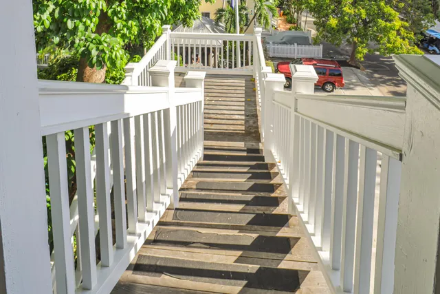 a view of a balcony with wooden floor and fence