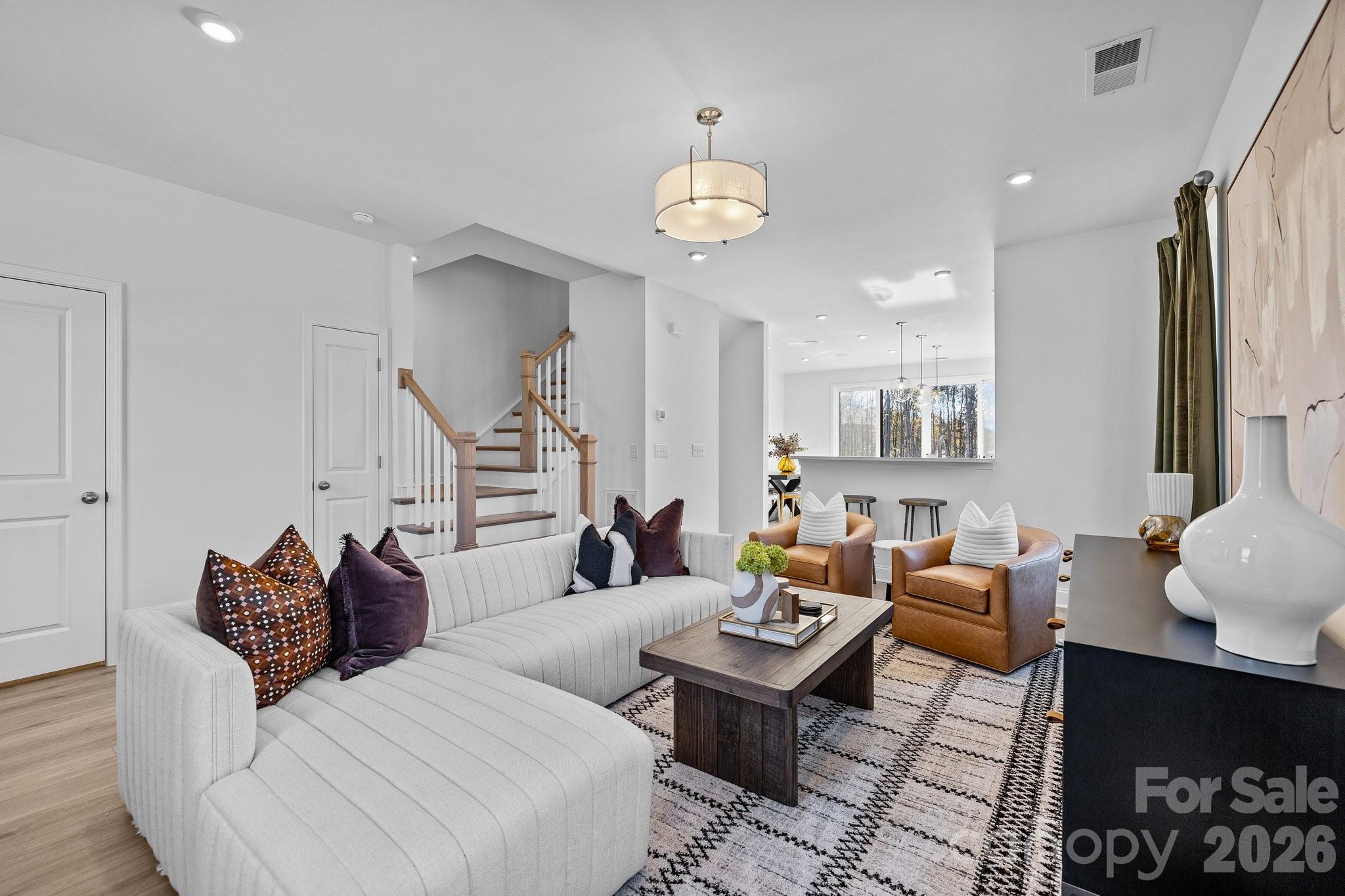 3025 Rozzelles Ferry Road Charlotte, NC 28208 - Photo 16 of 26 a living room with furniture a rug and a chandelier