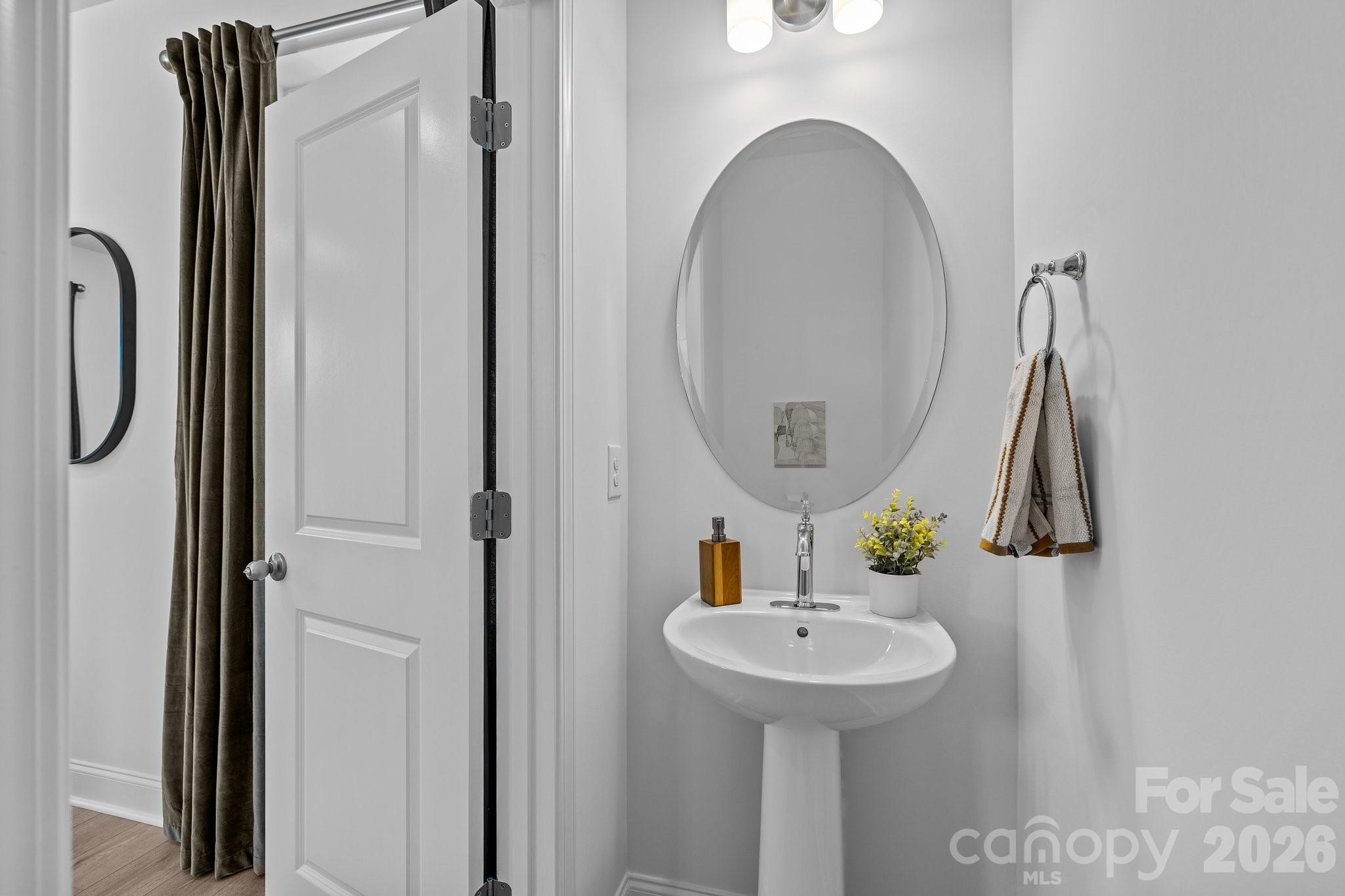3025 Rozzelles Ferry Road Charlotte, NC 28208 - Photo 18 of 26 a bathroom with a sink and mirror