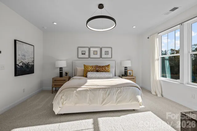 a bedroom with a large bed and a window