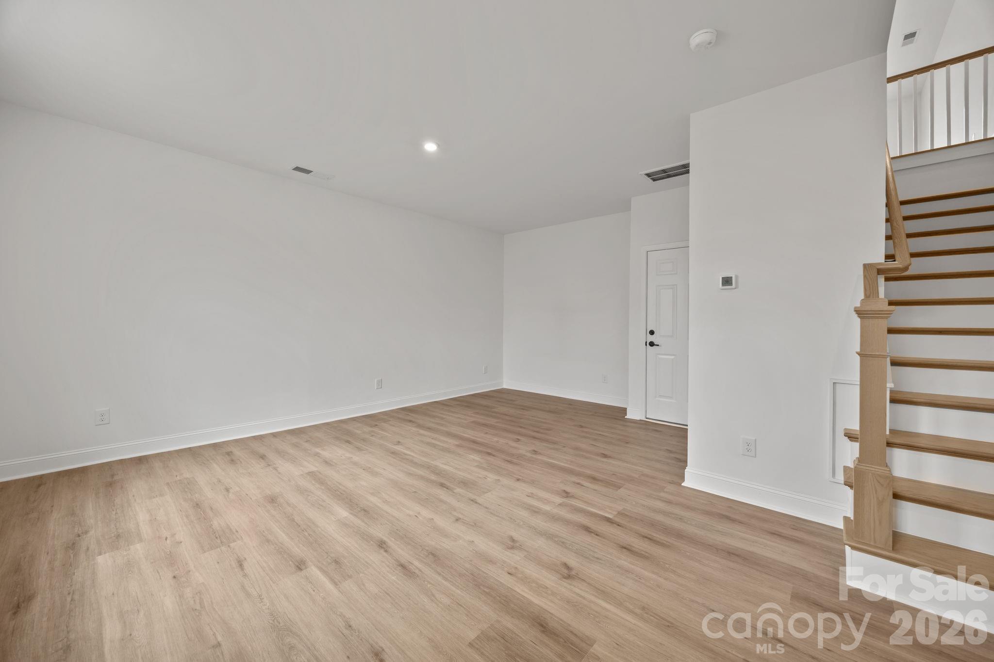 3025 Rozzelles Ferry Road Charlotte, NC 28208 - Photo 3 of 23 wooden floor in an empty room with a window