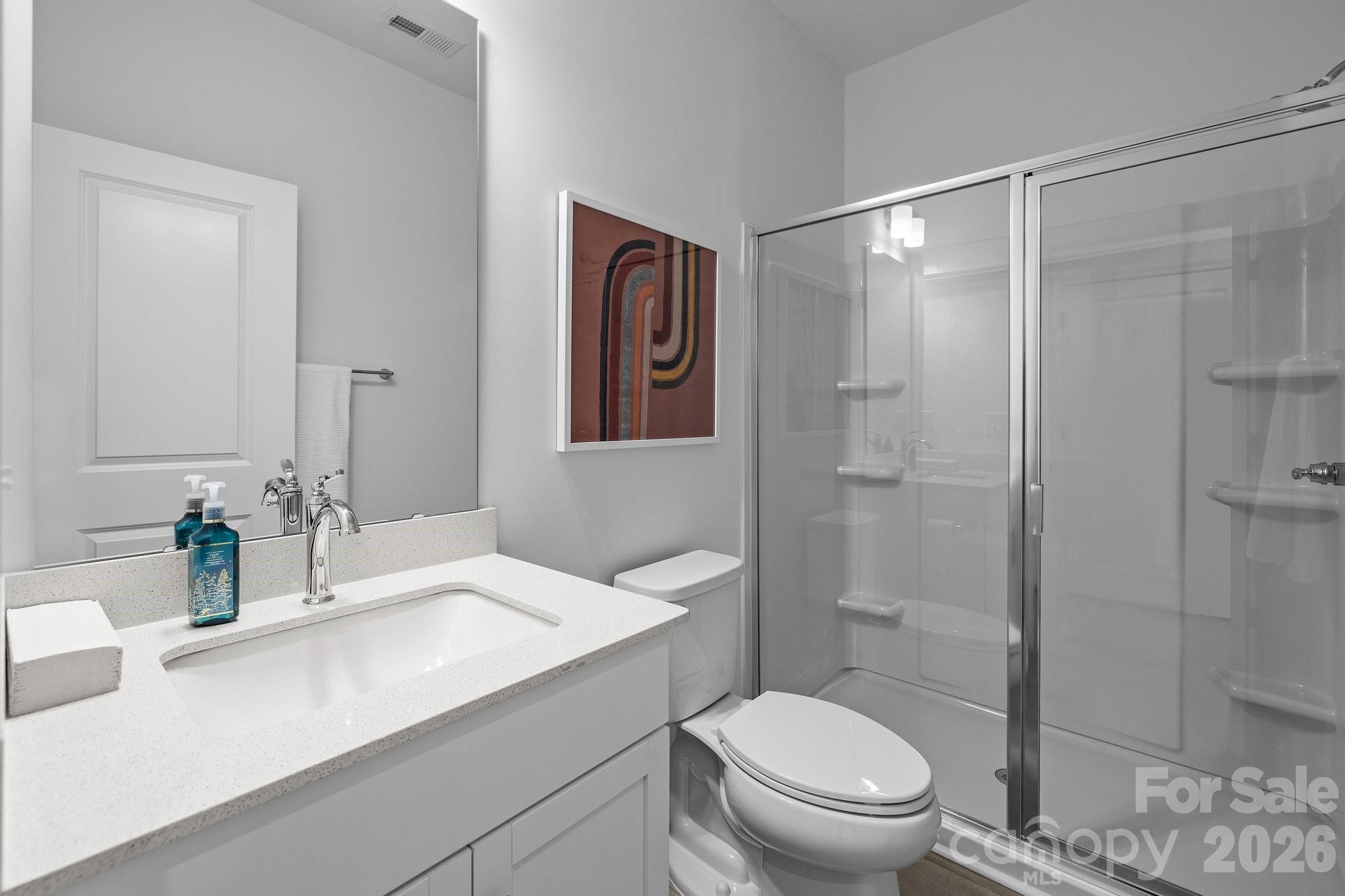 3025 Rozzelles Ferry Road Charlotte, NC 28208 - Photo 6 of 26 a bathroom with a sink a toilet and shower