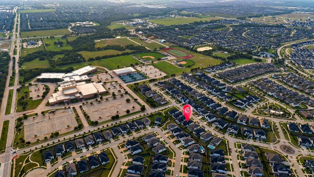 7852 Buffaloberry Road Frisco, TX 75035 - Photo 32 of 36 Aerial perspective showcasing a residential community with a large institutional building and sports fields