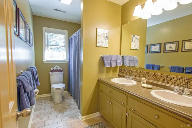 front view of a house with a yard and an trees